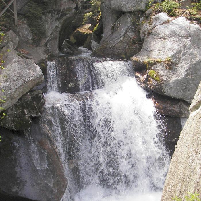 Water falls through granite rocks.