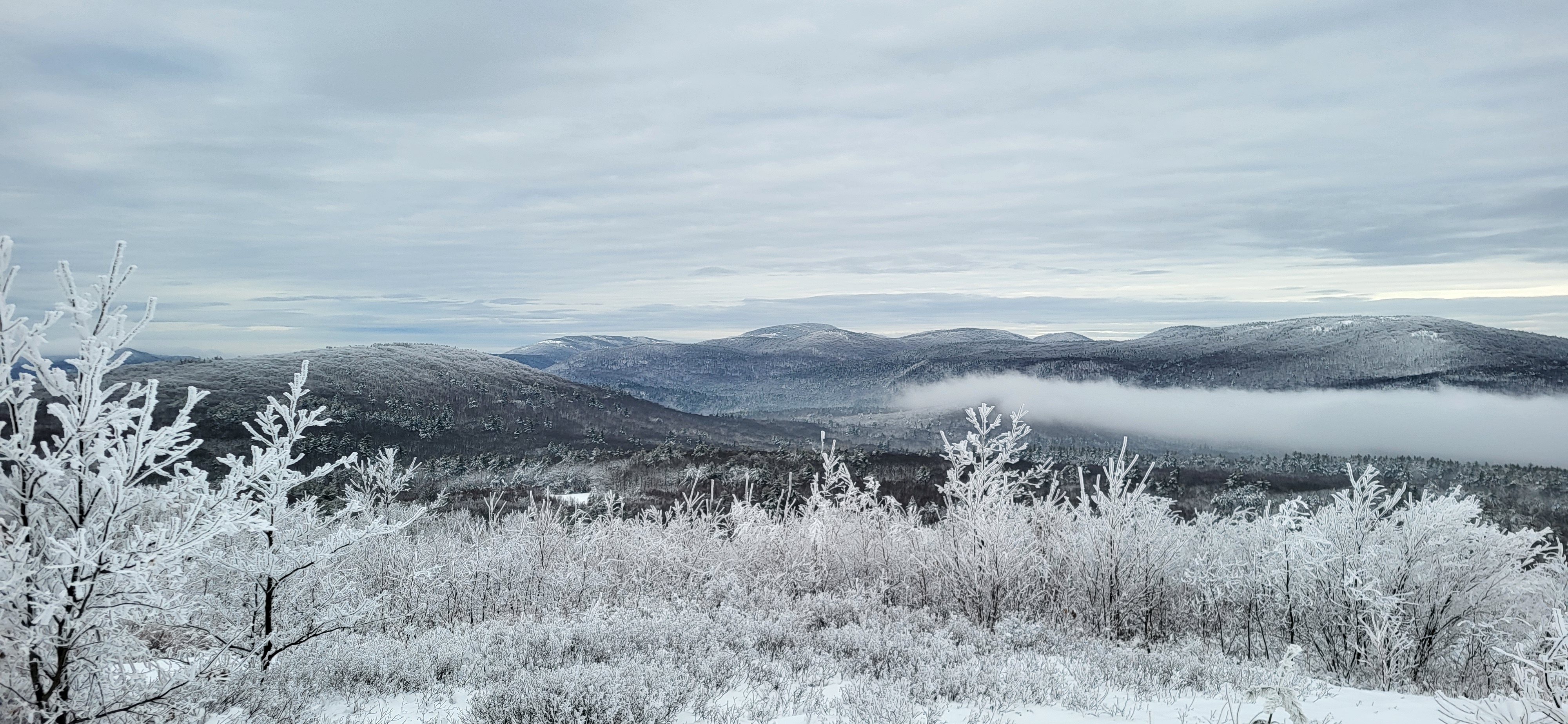 Snowy field with winter mountains in the background 