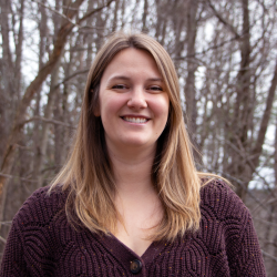 Sarah poses on the Conservation Center deck in winter.