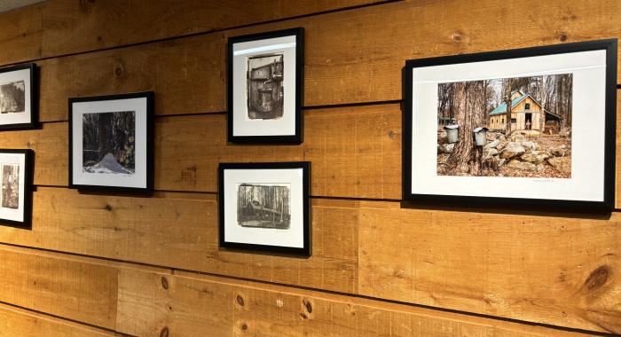 Photographs of sugar houses hang on the wall of the Conservation Center.