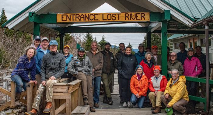 Volunteers pose in warm gear at the entrance to Lost River Gorge.