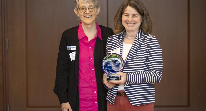 Susanne and Anne accept a blown glass award.