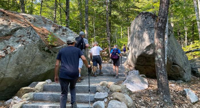 Hikers walk up new granite steps on the Main Trail.