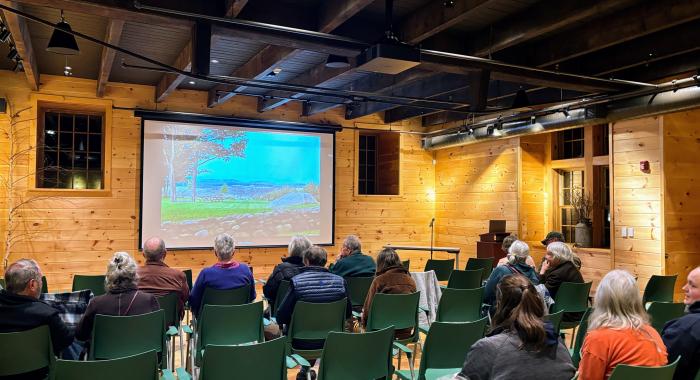 Attendees of a film screening sit waiting for it to begin.