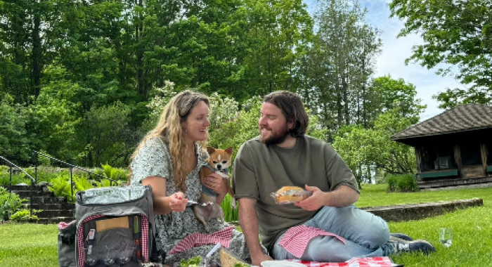 A couple has a picnic at The Rocks with their dog.