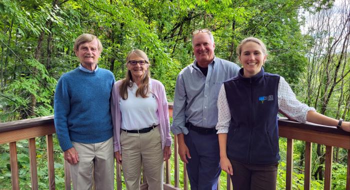 The Murray Family poses with President Jack Savage and Land Conservation Project Manager Leah Hart outside at the Conservation Center.