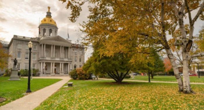 NH State House with fall leaves and colors blue sky