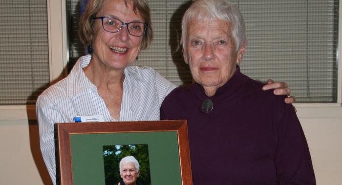 Jane Difley and Martha Chandler pose together with a plaque between them.