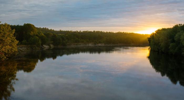 The sun sets over the Merrimack River near the Forest Society's conservation area.