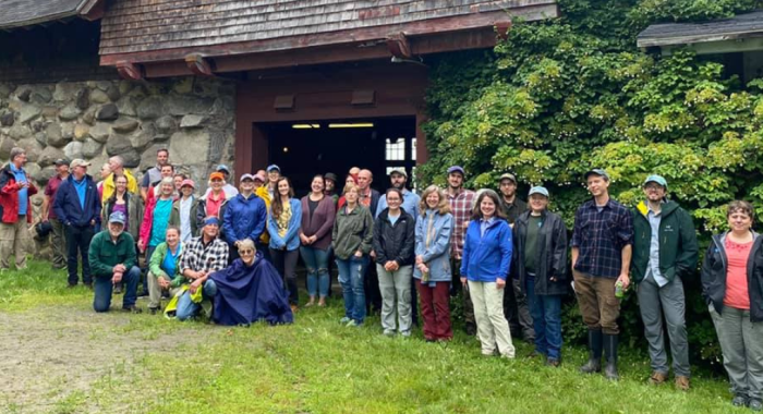 Staff and board pose in front of the Carriage Barn at The Rocks.