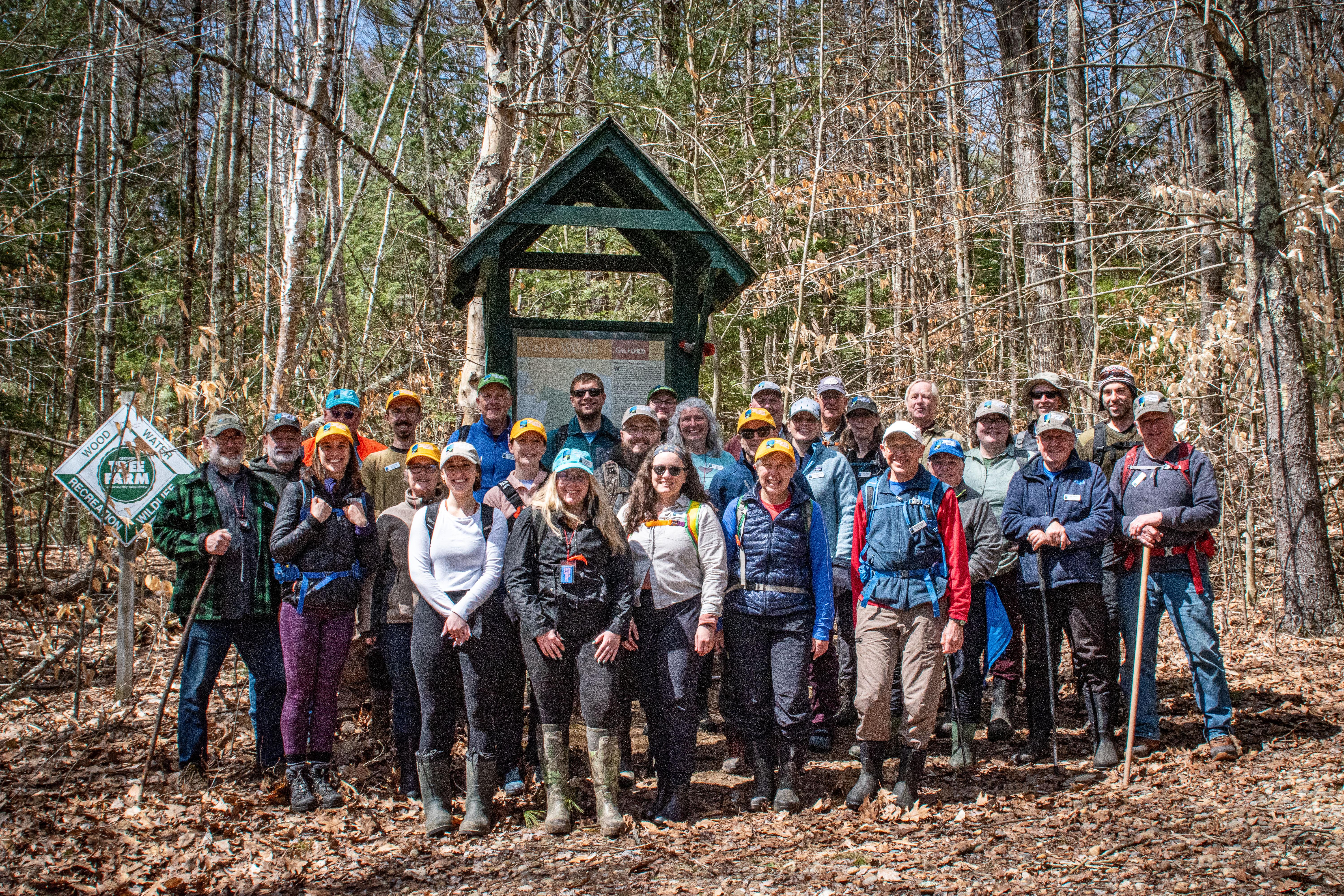 A large group of land stewards gather at the kiosk for a photo.