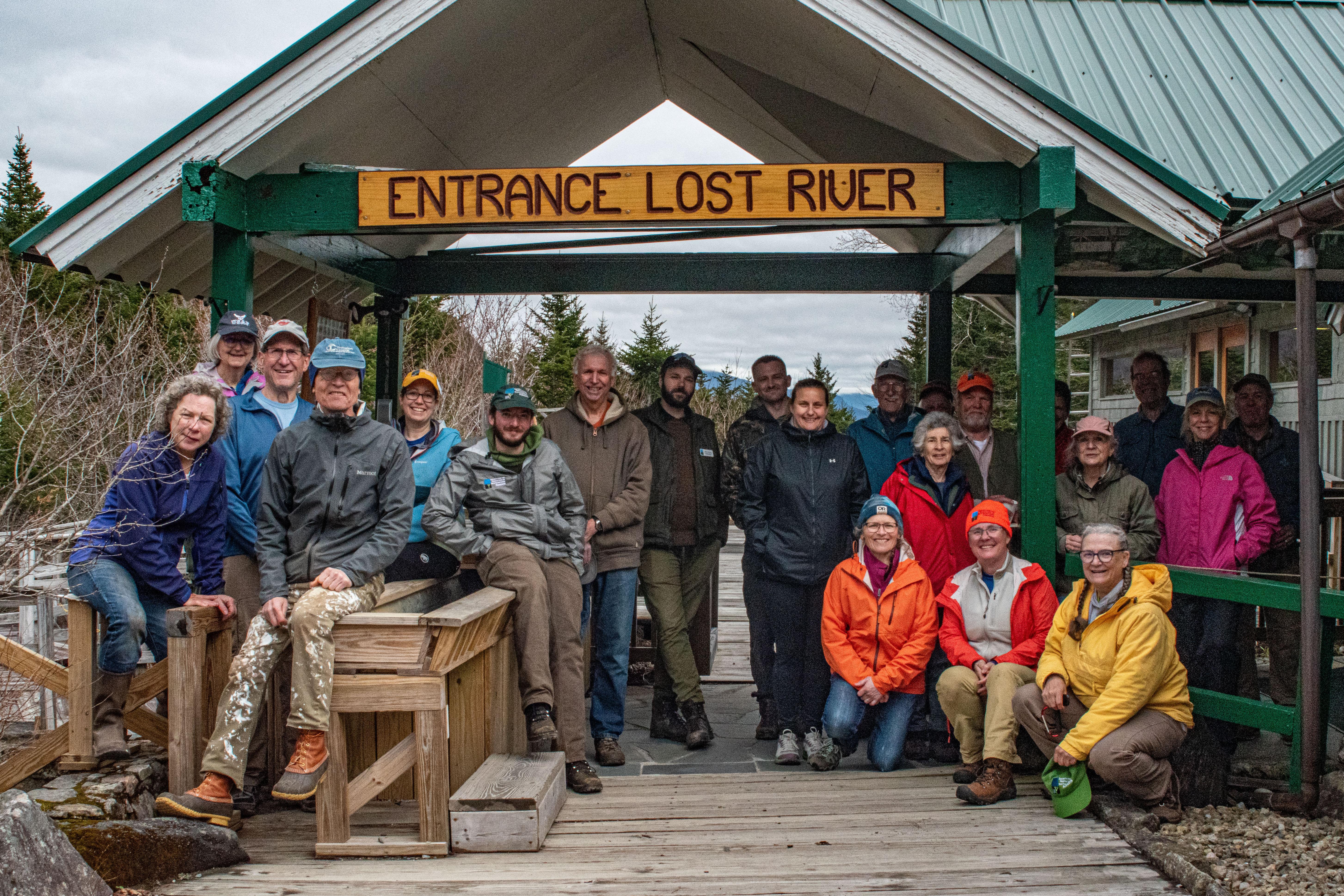 Volunteers pose in warm gear at the entrance to Lost River Gorge.