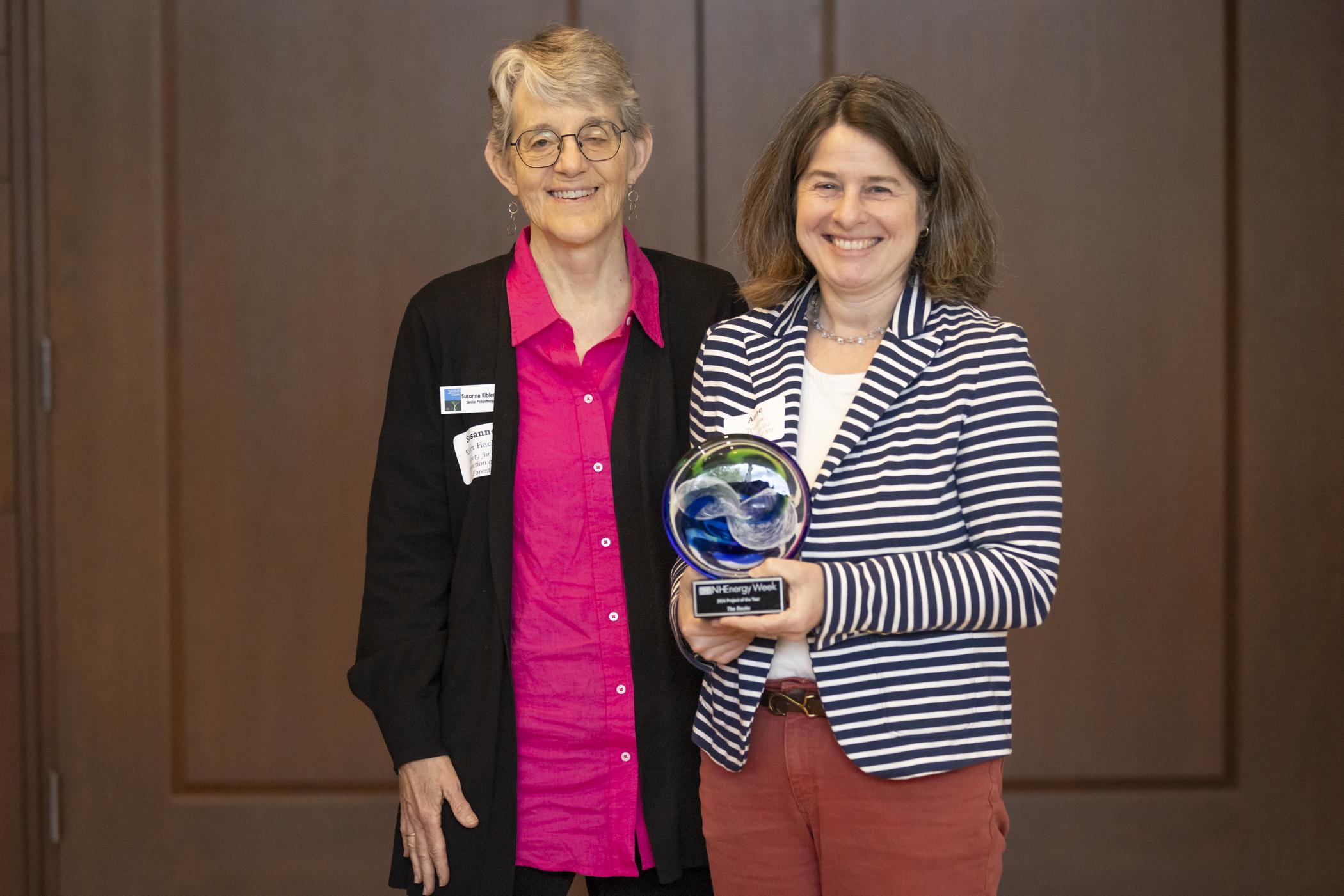 Susanne and Anne accept a blown glass award.