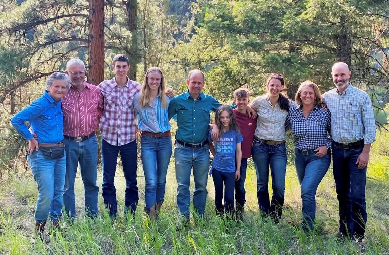 The Wells family poses together on their land.