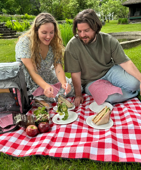 A couple has a picnic on a blanket at The Rocks.