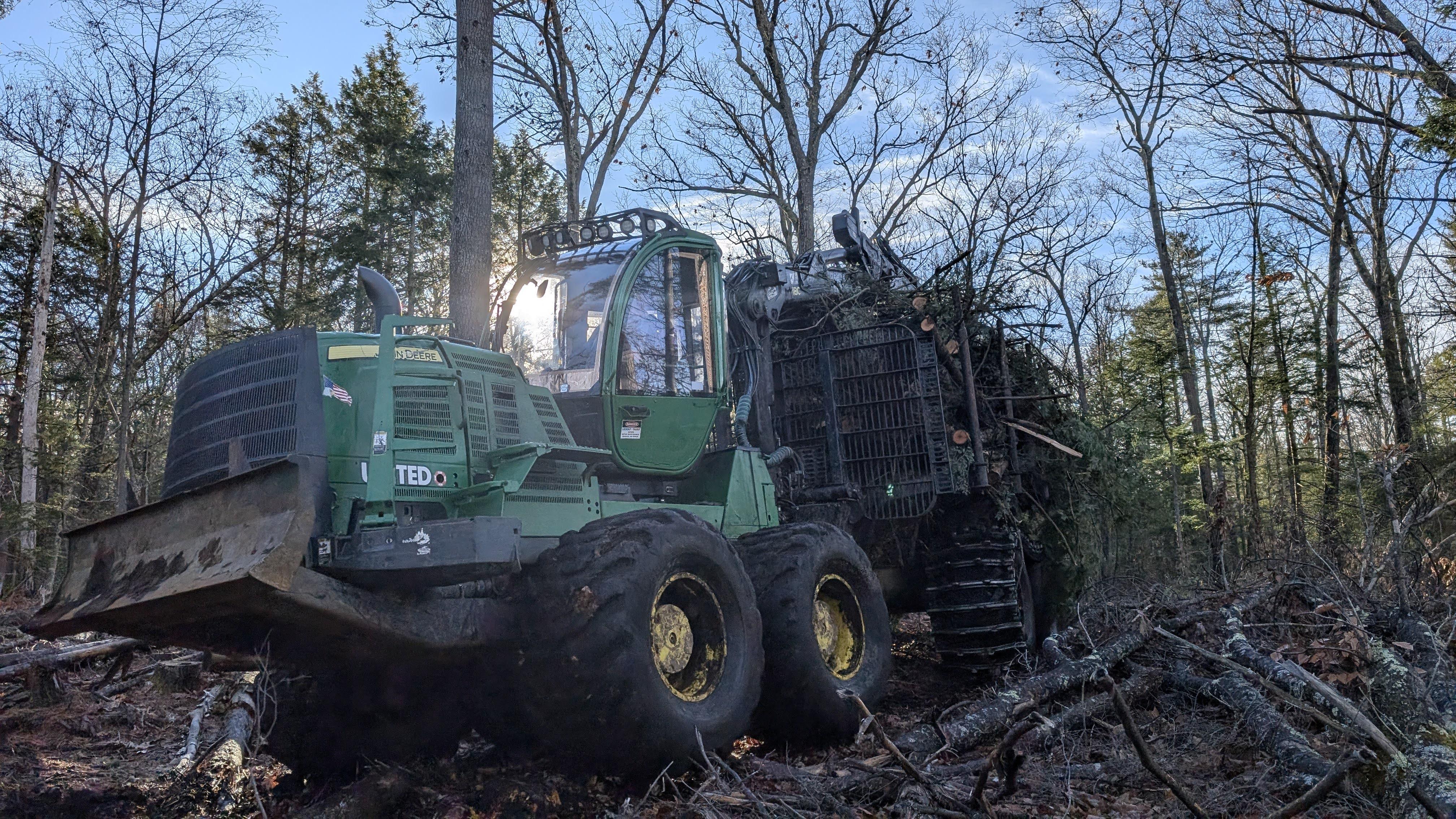 Forestry equipment carries logs across a logging trail