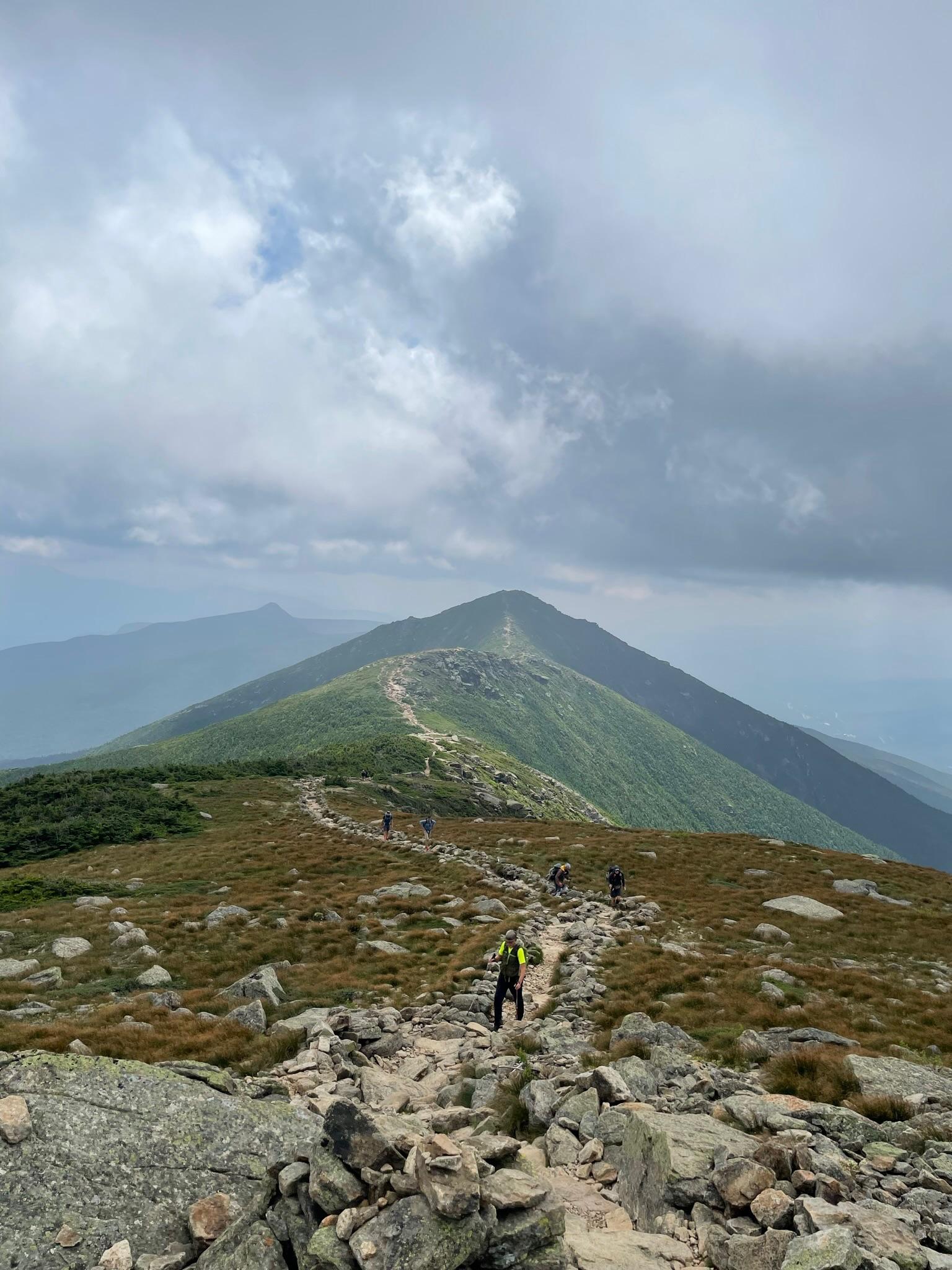 A rocky trail between two mountain peaks. 