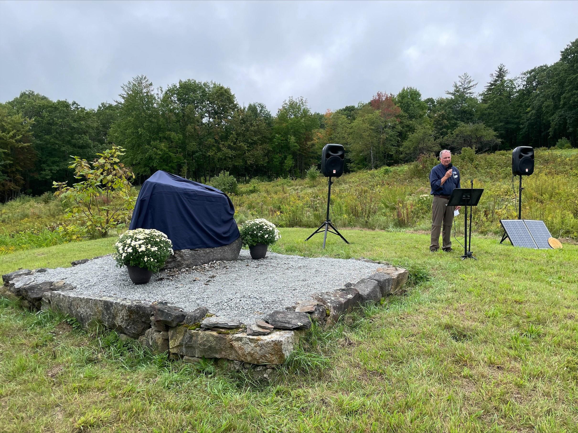 Forest Society President Jack Savage speaks in front of the marker at the event.