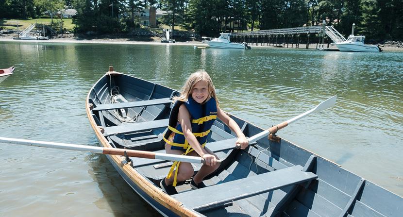 Camper rows a boat on Sagamore Creek for Gundalow Company outdoor camps