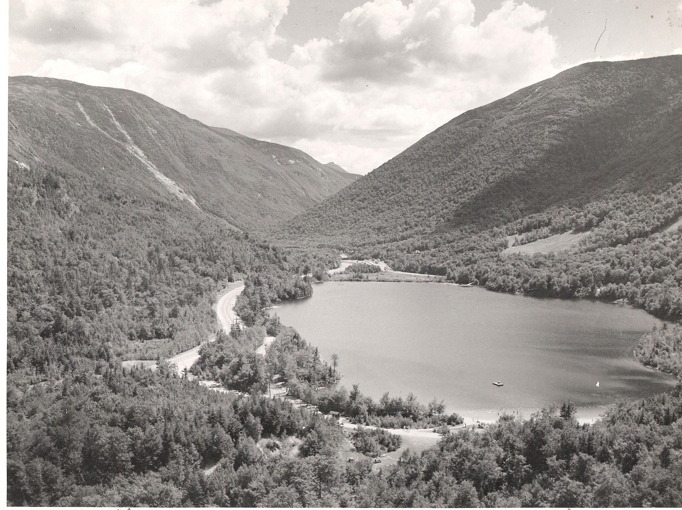 A black and white view of the forested White Mountains overlooking Echo Lake.