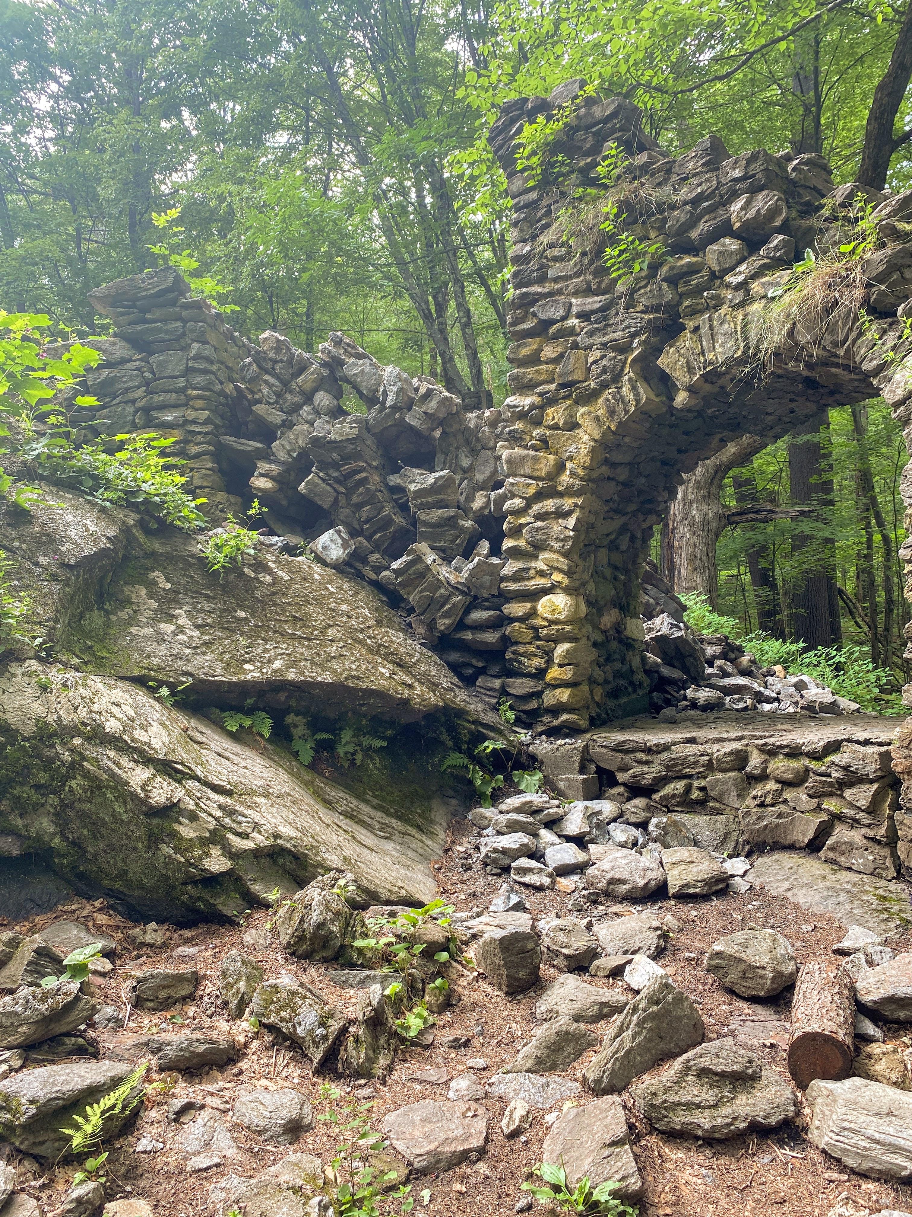 Stones are scattered below where the top arch of the staircase used to stand, with the two remaining arches below.