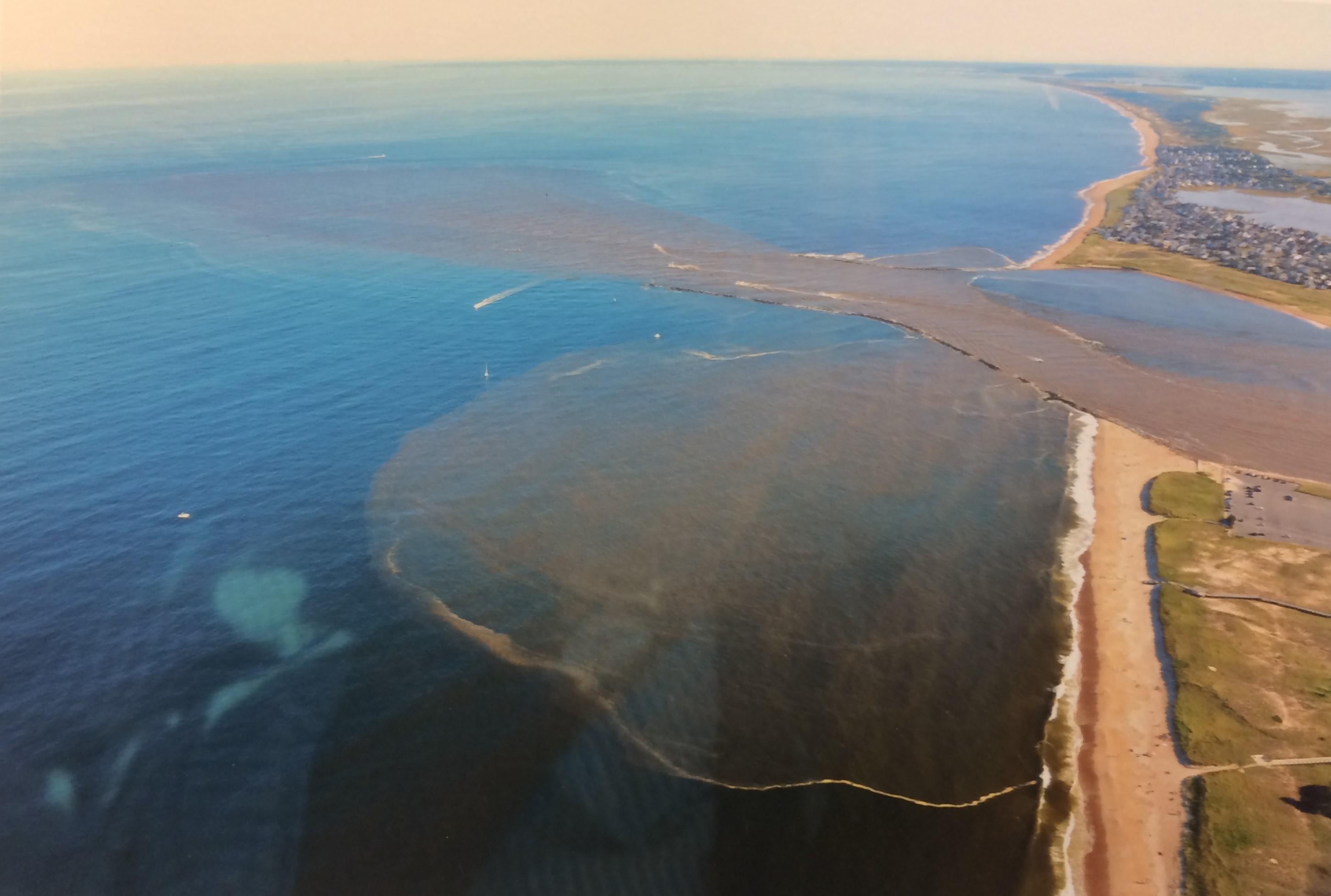 Polluted stormwater runoff can be seen spilling into the Gulf of Maine from overhead.