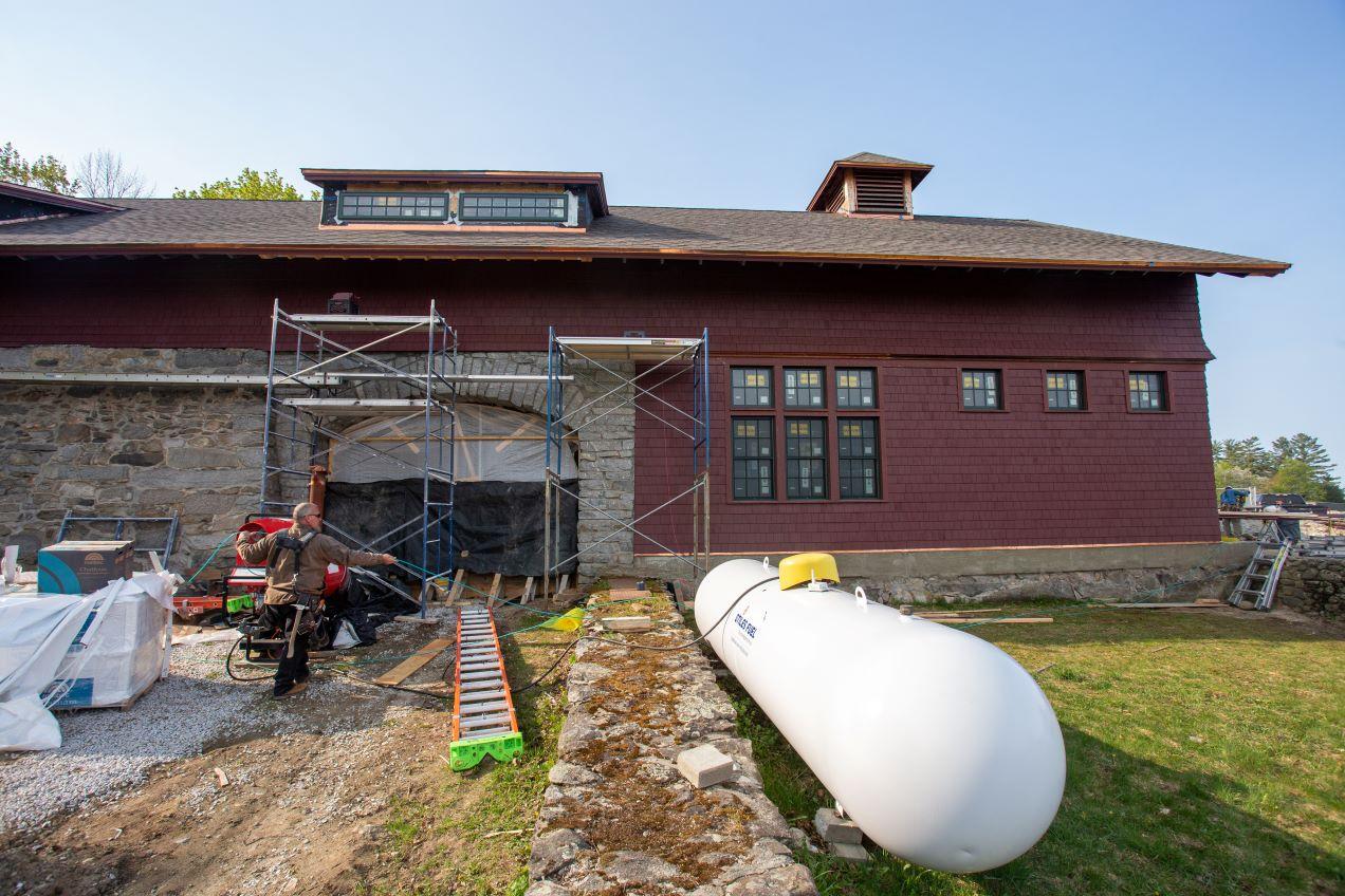 A view of the iconic exterior of the Carriage Barn doors under construction into a beautiful window.