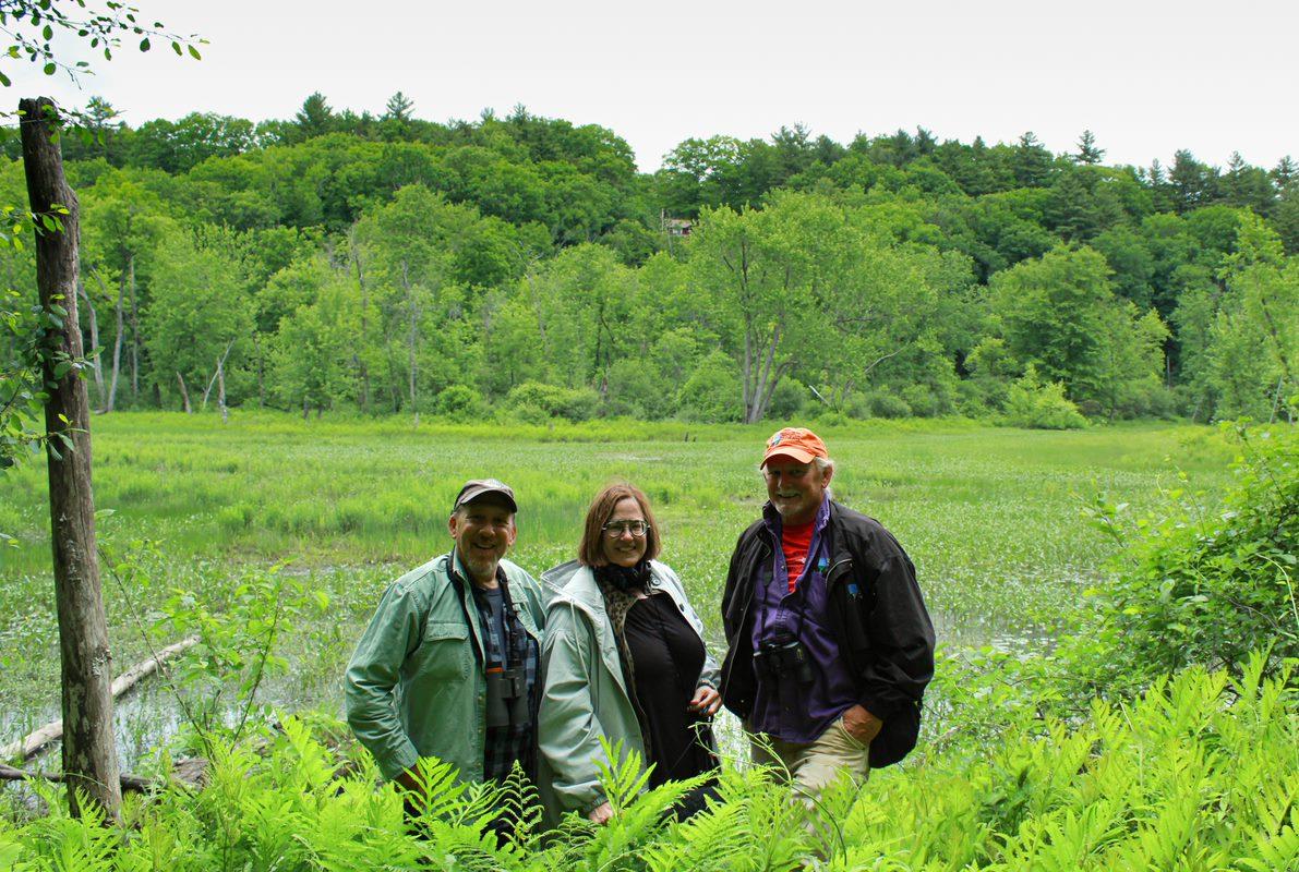 The team sits on a bench on the floodplain in spring.