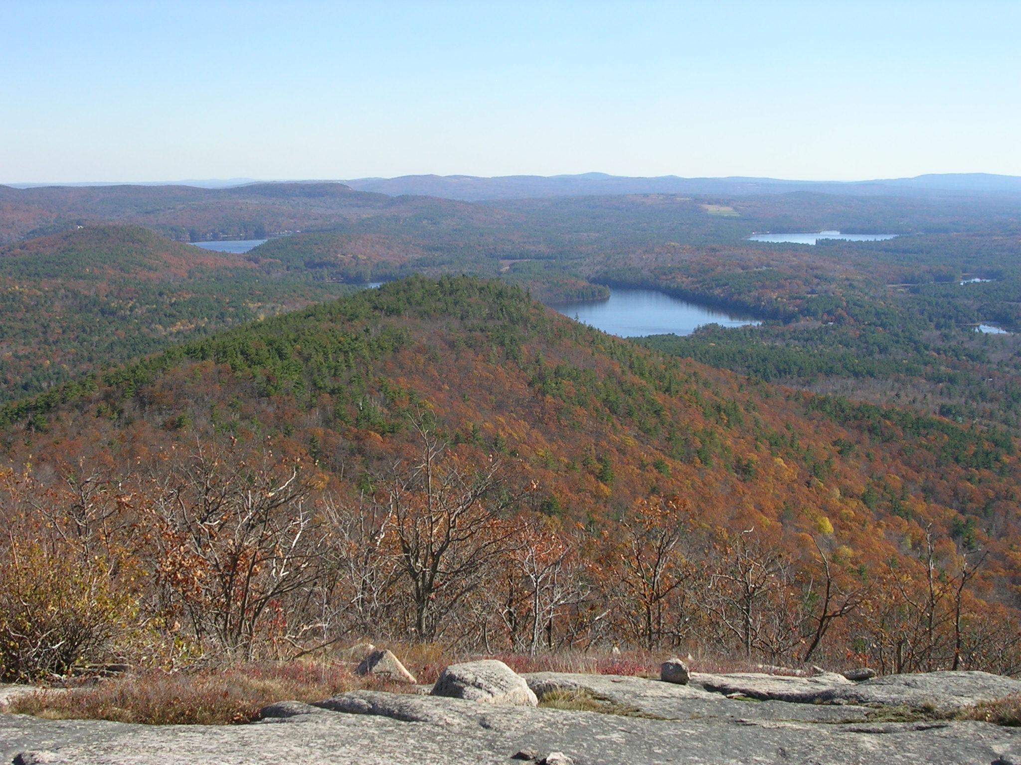 Water body view from summit of mountain in spring blue sky background