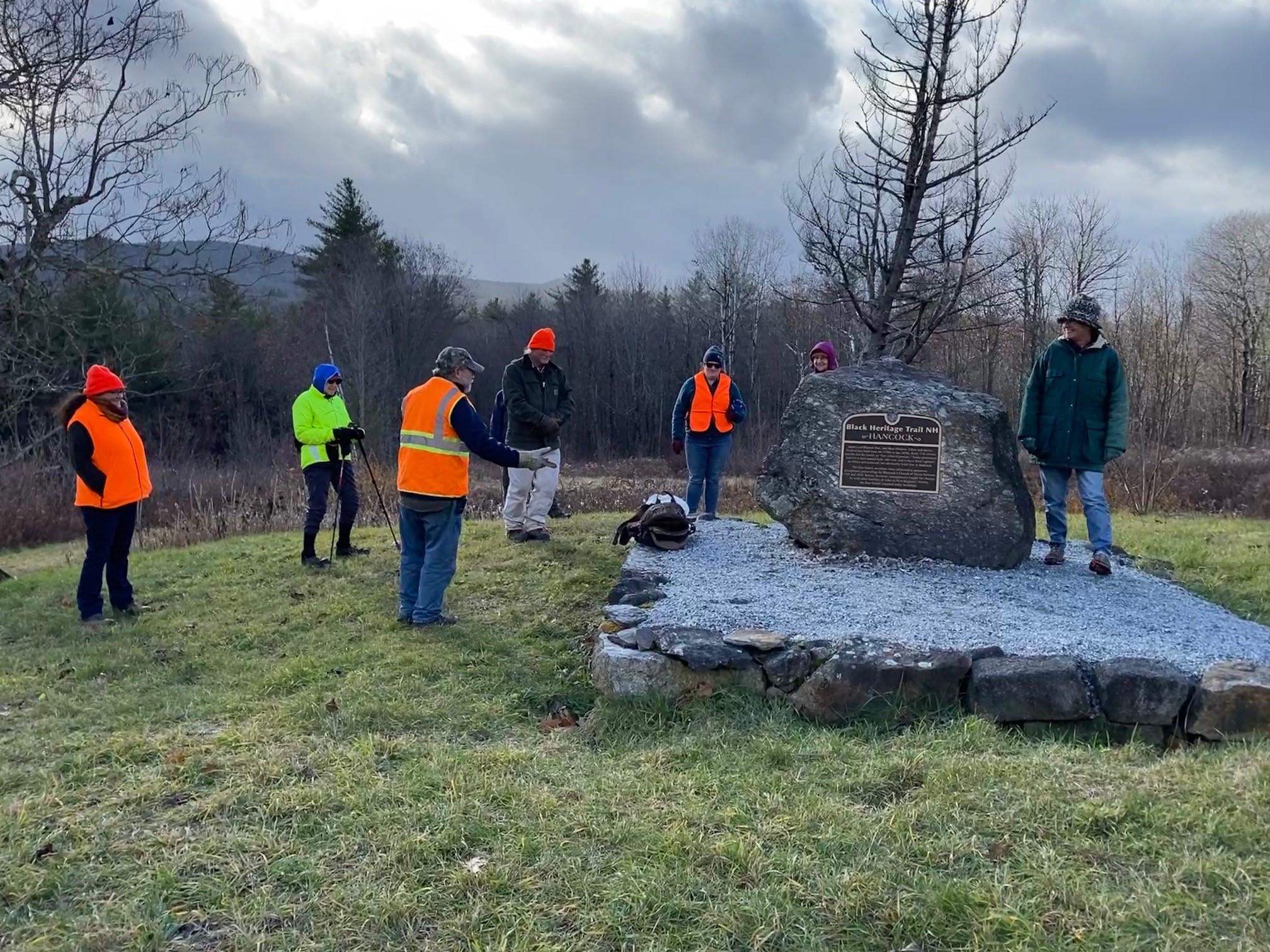 NHLTC members stand in a circle as historian Eric Aldrich explains his research which led to the marker's dedication.