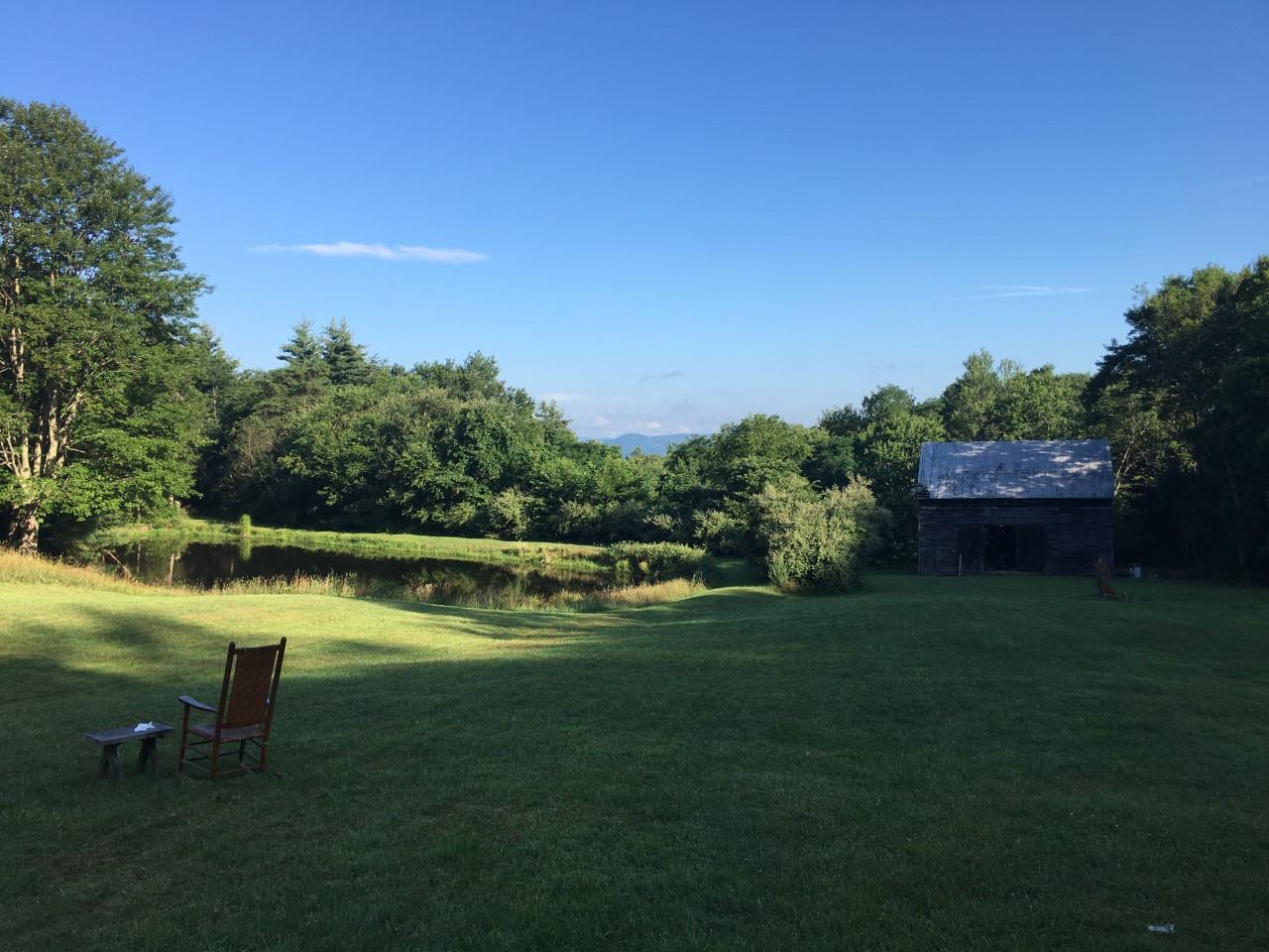 A green field that looks out to the mountains 