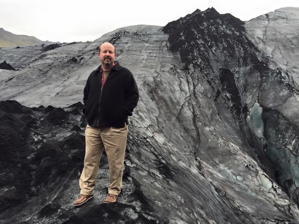 Dr. Mann stands atop a glacier.