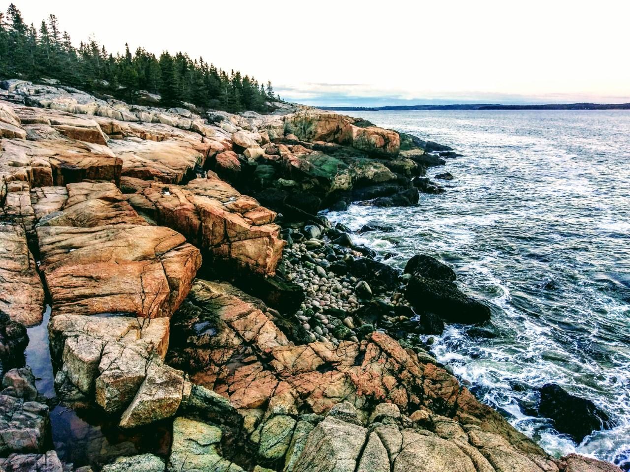 A rocky shore with blue ocean waters