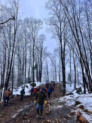 The group descending a skid trail made up of slash