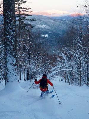Skiing down the East Branch glade in the White Mountains with views of Mt. Washington