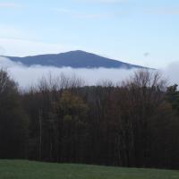 The mountain from a distance covered partially by fog.