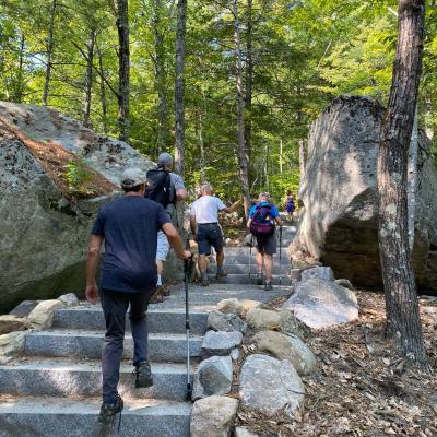 Hikers walk up the new granite steps on the Main Trail.