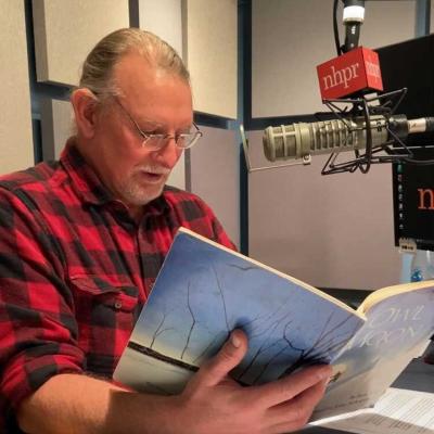 Dave Anderson sits in the recording studio at NHPR holding "Owl Moon."