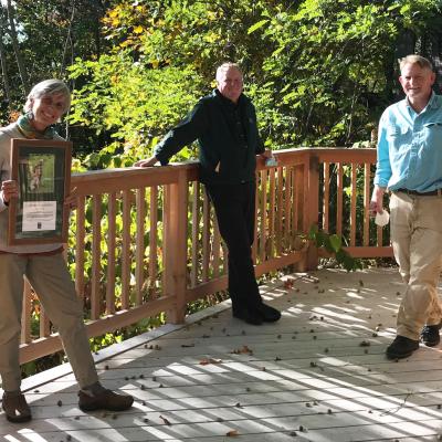 Ellen Kenny poses on the Conservation Center deck with her award.