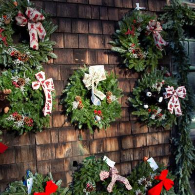 Christmas wreaths for sale hang on the historic Carriage Barn at The Rocks.