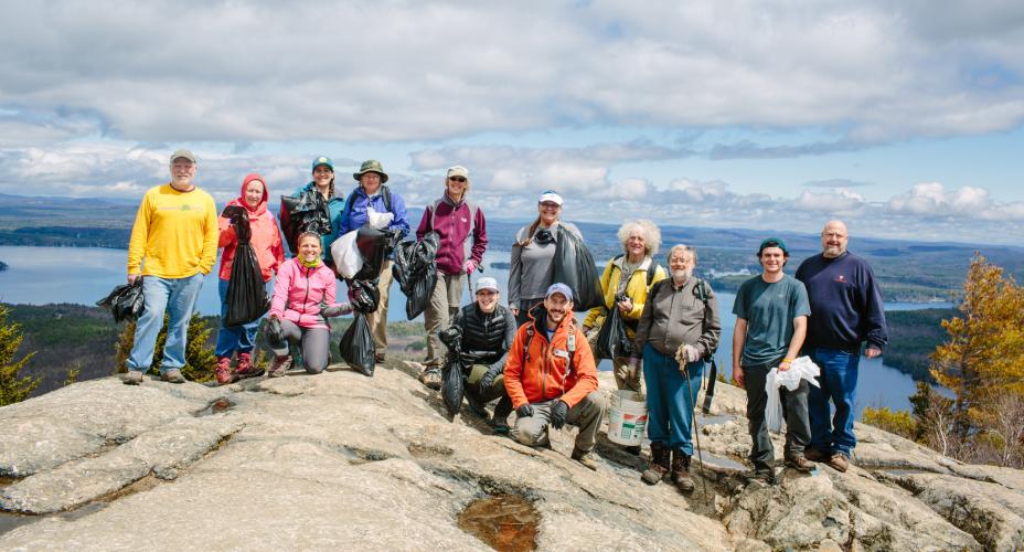   Volunteers take a break to pose for a photo on the summit of Mount Major.