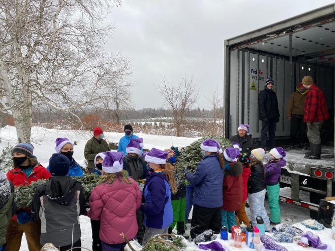 Bethlehem Elementary fifth-graders help load the trees into a FedEx truck.