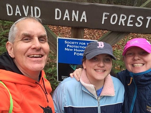 Scott Casper and his family pose by a Forest Society sign at Dana Forest during the 2020 5 Hikes Challenge.