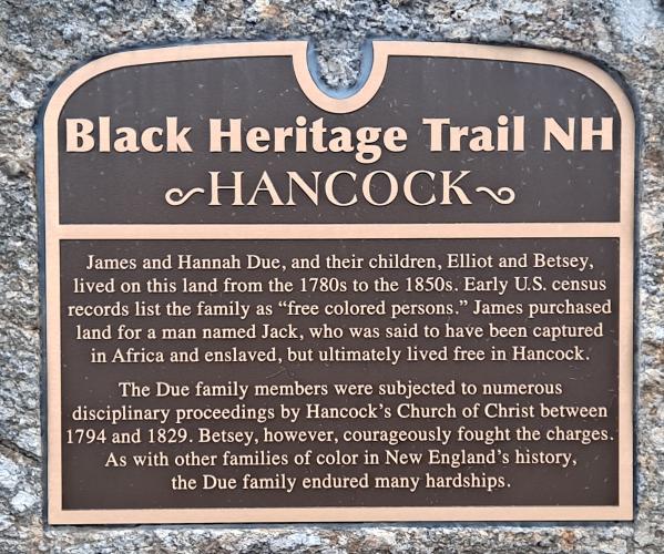 The marker unveiled on a stone at the property is black and gold.