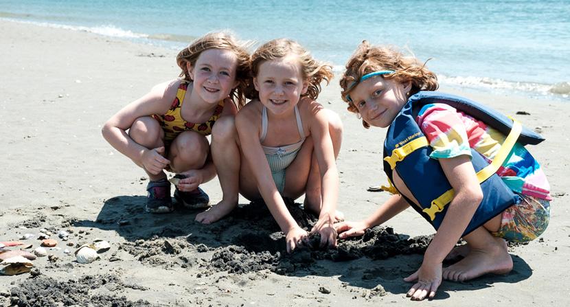 Gundalow Company Campers play in the sand along Sagamore creek