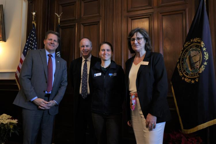 Forest Society staff Leah Hart poses with Governor Sununu and LCHIP leaders.