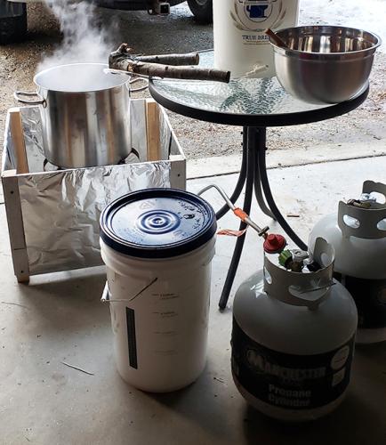 Steve Junkin's evaporation set-up in his garage includes plastic buckets, propane tanks and more.