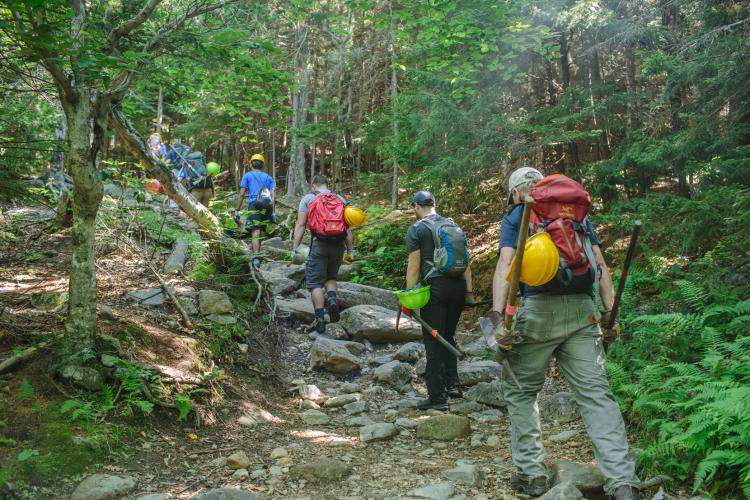 Volunteers hike in tools for trail restoration projects on Mount Monadnock