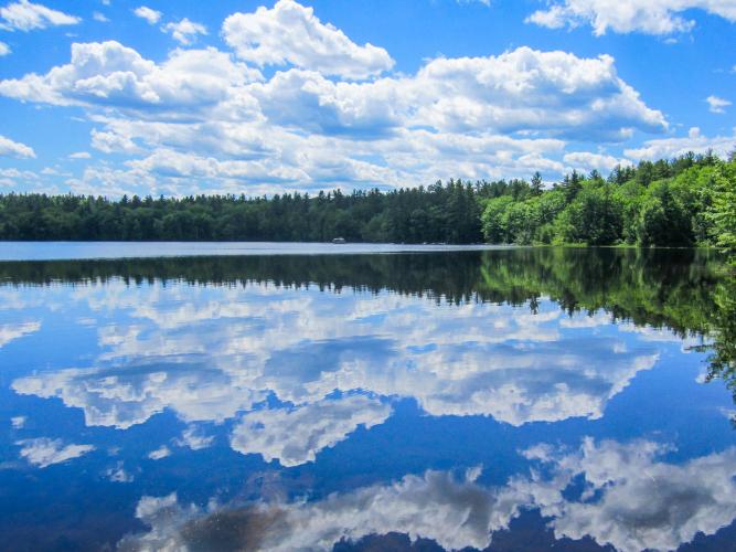 A reflection of blue skies and clear water at Lake Massabesic.