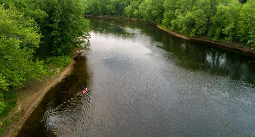 A kayaker paddles on the Merrimack River in Canterbury, New Hampshire